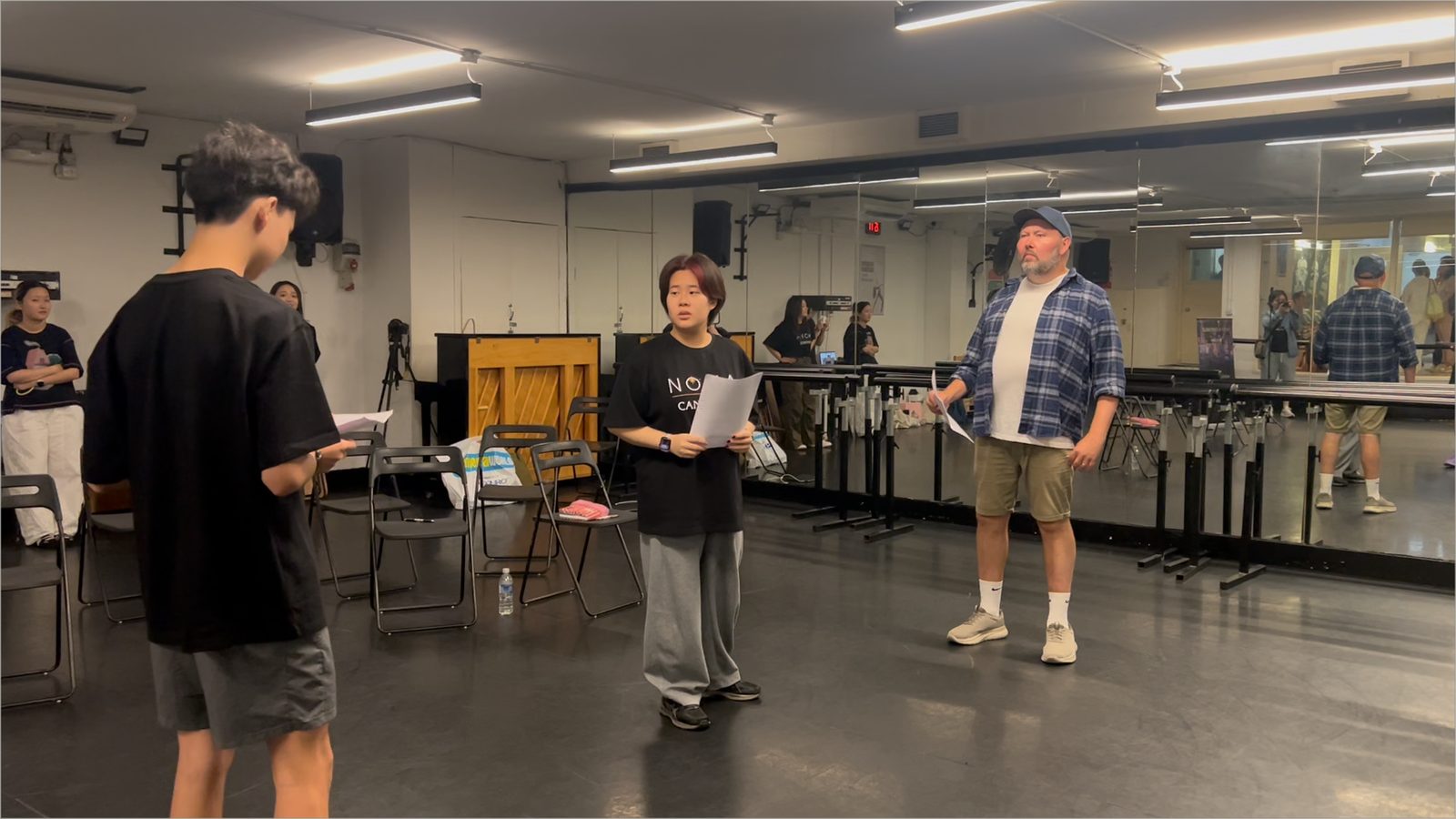 Students working with a practitioner in a rehearsal room