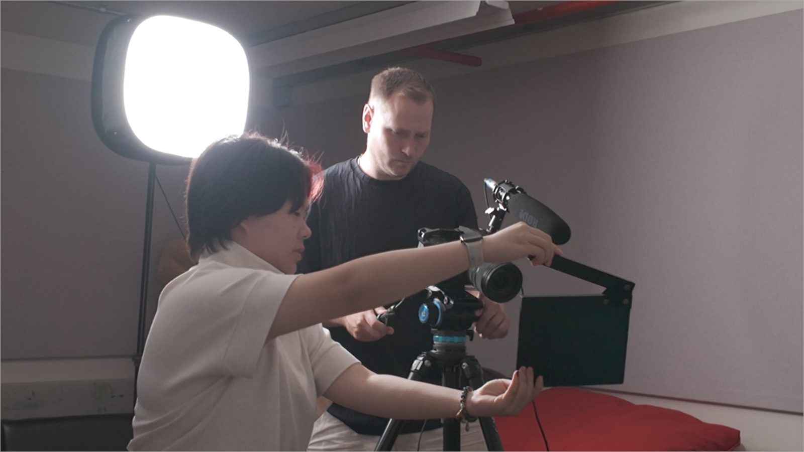 A student behind a professional camera